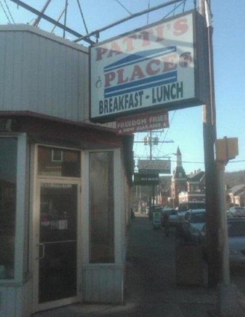 Sign for "Patti's Place" restaurant, advertising breakfast and lunch, with a view of the storefront and surrounding area.