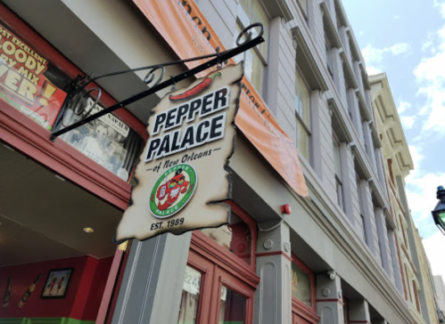 Sign for "Pepper Palace" in New Orleans, featuring a chili pepper logo and established date of 1989.