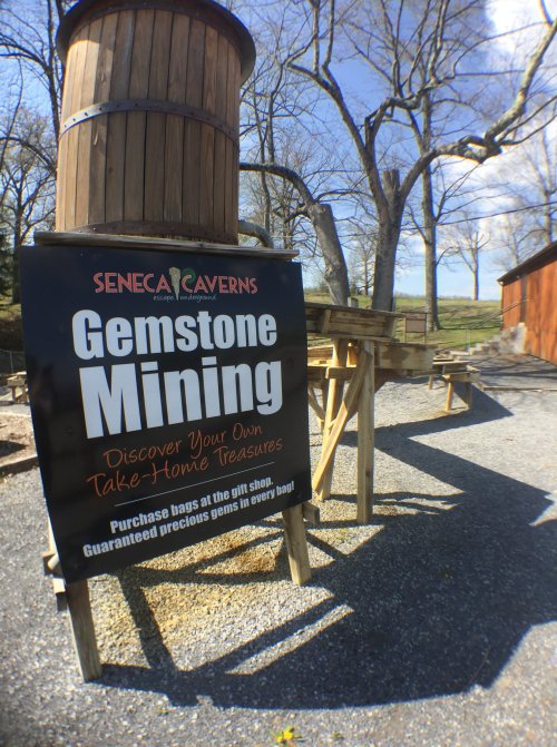 Sign for Seneca Caverns Gemstone Mining, inviting visitors to discover and purchase take-home treasures.