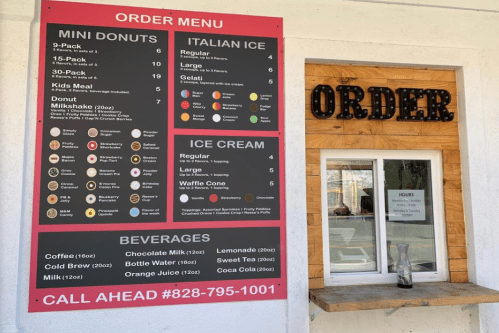 Menu board displaying mini donuts, Italian ice, ice cream, and beverages with a call-ahead number.