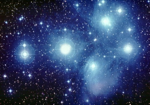 A starry night sky filled with bright stars and a deep blue cosmic background.