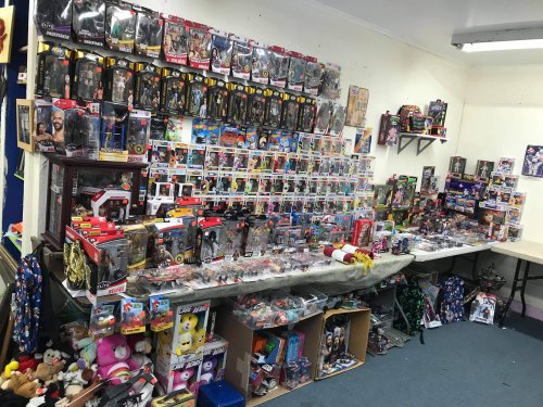 A room filled with shelves and tables displaying a variety of action figures, collectibles, and toys.