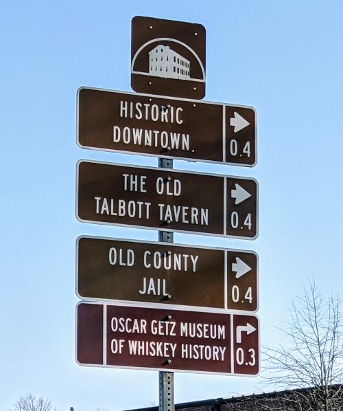 Signpost with directional arrows for Historic Downtown, The Old Talbott Tavern, Old County Jail, and Oscar Getz Museum.
