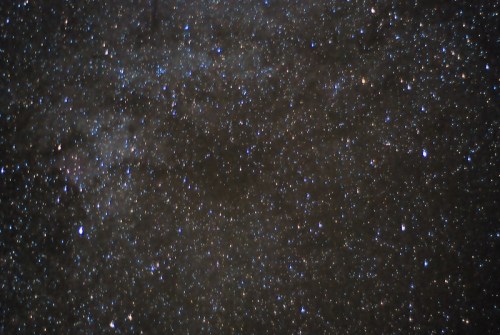A vast night sky filled with countless stars, creating a shimmering, cosmic backdrop.