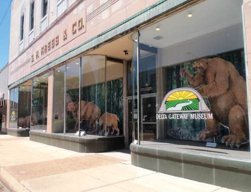 Exterior of the Delta Gateway Museum featuring large animal murals in the windows and a sign above the entrance.