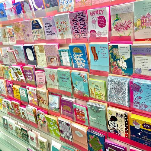 A colorful display of greeting cards for various occasions, featuring messages for mothers and grandmothers.