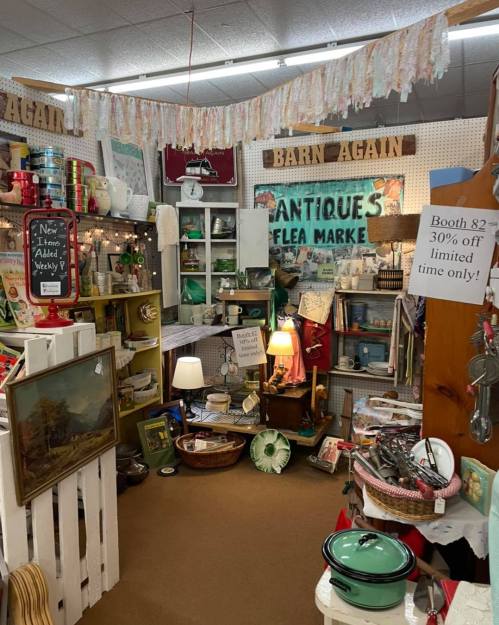A cozy antique shop filled with vintage items, decor, and signs, creating a charming, nostalgic atmosphere.