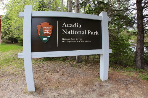 Sign for Acadia National Park, featuring the park logo and information about the National Park Service.