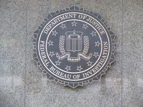 Seal of the Federal Bureau of Investigation, featuring the words "Department of Justice" and symbols of integrity and bravery.