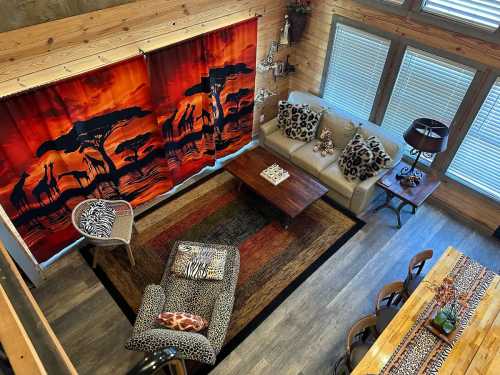 Cozy living room with animal-themed decor, vibrant curtains, a wooden table, and a mix of patterned furniture.