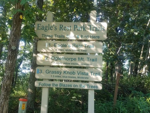 Signpost at Eagle's Rest Park Trails listing three trails: Eagle's Rest, Oglethorpe Mt., and Grassy Knob Vista.