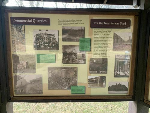 Informational display about commercial quarries and the use of granite, featuring historical photos and descriptions.