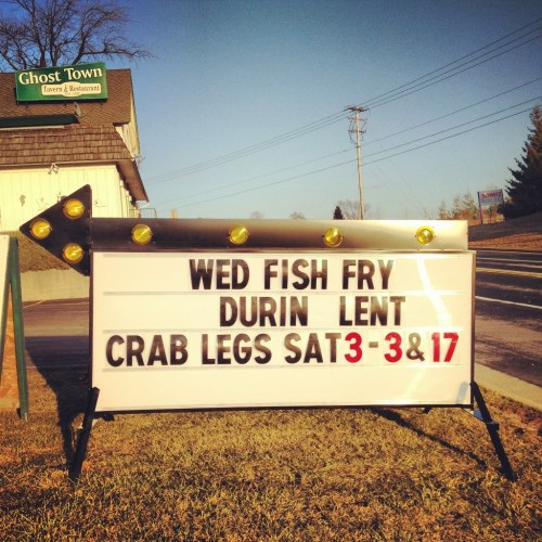 Sign advertising a Wednesday fish fry during Lent and crab legs on Saturdays, March 3 and 17, outside a restaurant.