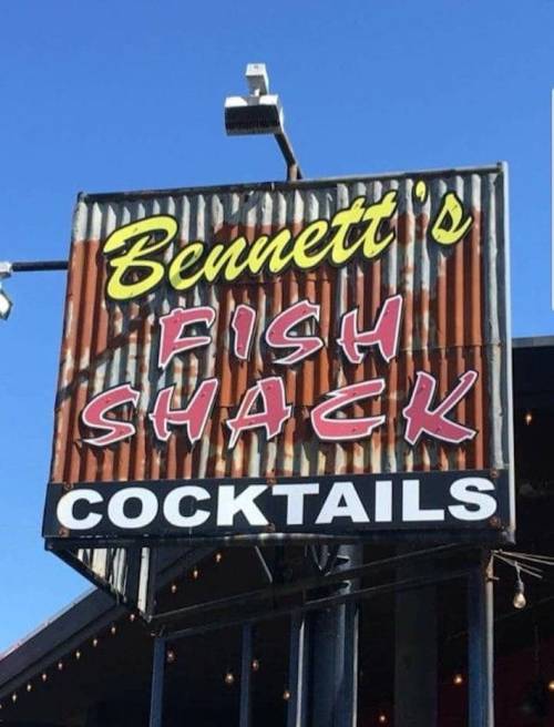 Sign for Bennett's Fish Shack featuring a rustic design, with "Fish Shack" and "Cocktails" prominently displayed.