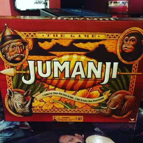 A close-up of the Jumanji board game box featuring animals and adventure-themed artwork.