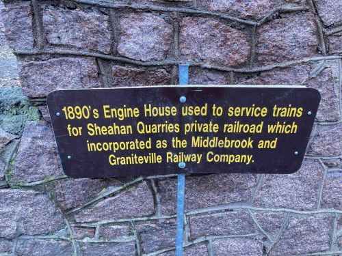 Sign on a stone wall detailing the 1890s Engine House for Sheahan Quarries' private railroad.
