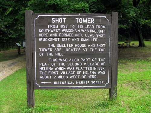 Sign marking the Shot Tower, detailing its history from 1833 to 1861 and its significance in the village of Helena.