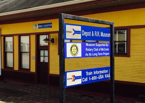 Signage for the Depot & R.R. Museum, featuring Amtrak information and support from the Rotary Club of McComb.