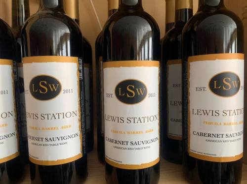 Bottles of Lewis Station Cabernet Sauvignon, labeled as tequila barrel aged, displayed on a shelf.
