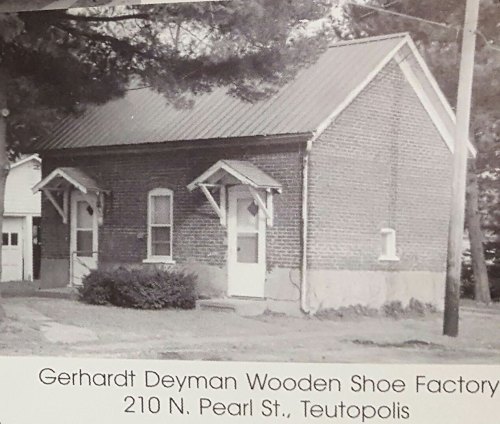 Black and white photo of the Gerhardt Deyman Wooden Shoe Factory, a brick building with a metal roof in Teutopolis.