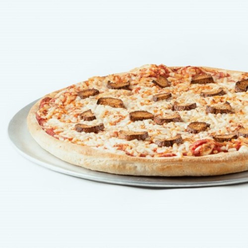 A pizza on a silver tray topped with cheese and slices of meat.
