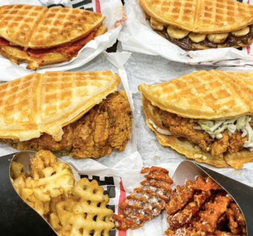 A variety of waffle sandwiches filled with chicken, chocolate, and banana, alongside waffle fries and sweet potato fries.