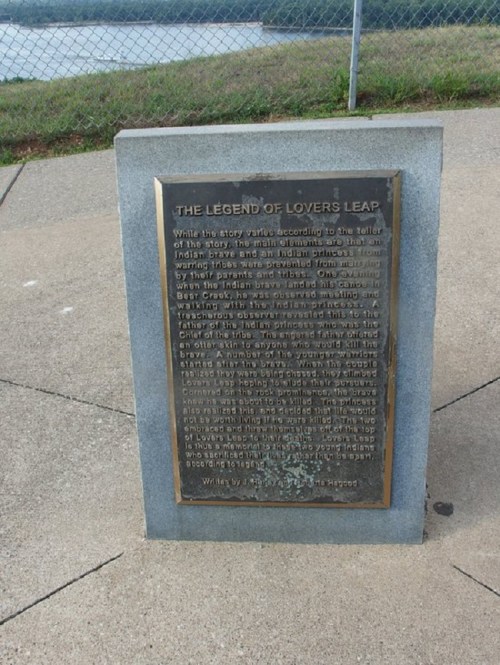 A plaque titled "The Legend of Lovers Leap" with text about a local legend, set against a scenic background.