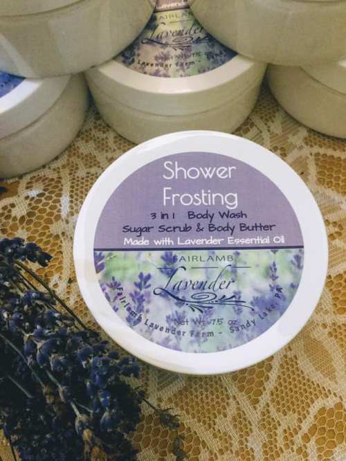 A jar of lavender-scented shower frosting labeled as a 3-in-1 body wash, sugar scrub, and body butter.