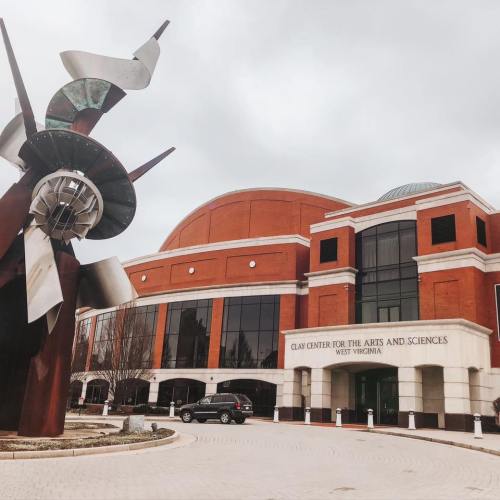 Exterior view of the Clay Center for the Arts and Sciences in West Virginia, featuring a large metal sculpture in front.