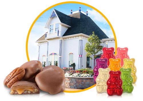 A colorful house with candy, featuring chocolate-covered treats and gummy bears in various colors.