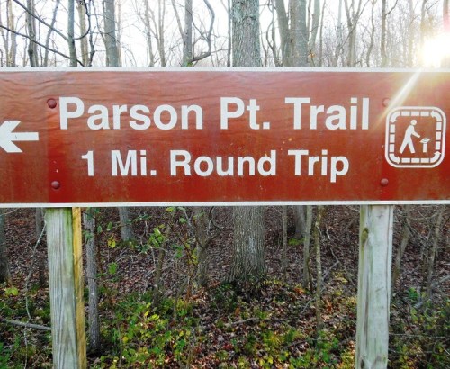 Sign for Parson Pt. Trail indicating a 1-mile round trip, with a hiker icon and an arrow pointing left.