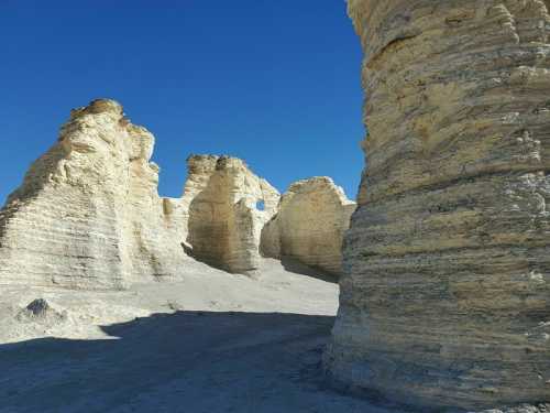 Rock formations in a desert landscape under a clear blue sky.