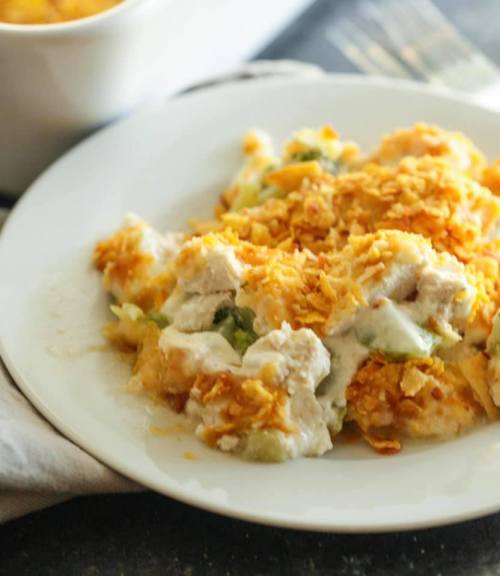 A plate of creamy casserole topped with crunchy golden cornflakes and mixed vegetables.