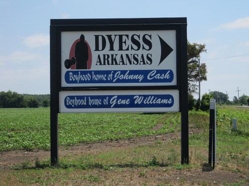 Sign for Dyess, Arkansas, noting it as the boyhood home of Johnny Cash and Gene Williams.