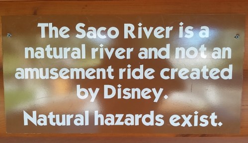 Sign warning that the Saco River is a natural river with hazards, not a Disney amusement ride.
