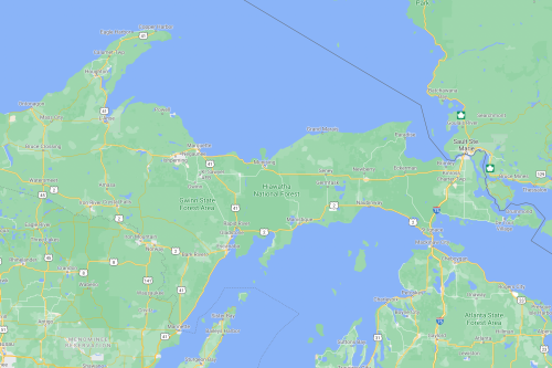 Map showing Hiawatha National Forest and surrounding areas in Michigan, with lakes and highways marked.