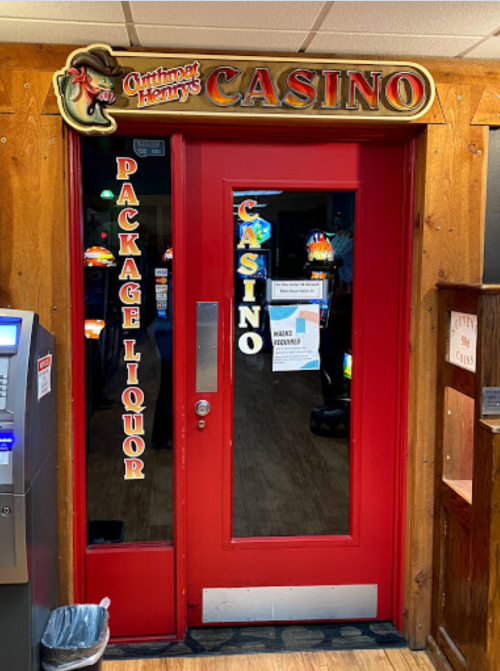 Red double doors with "Casino" and "Package Liquor" signs, leading into a brightly lit gaming area.