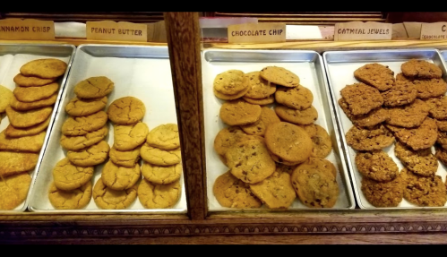 Trays of assorted cookies: cinnamon crisp, peanut butter, chocolate chip, and oatmeal jewels, neatly arranged.