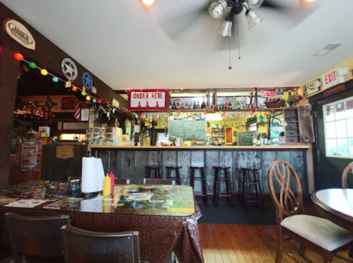 Cozy diner interior with a wooden counter, colorful decor, and tables set for dining.
