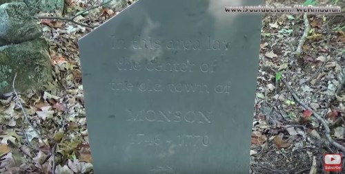 Gravestone marking the site of the old town of Monson, dated 1746-1770, surrounded by foliage.
