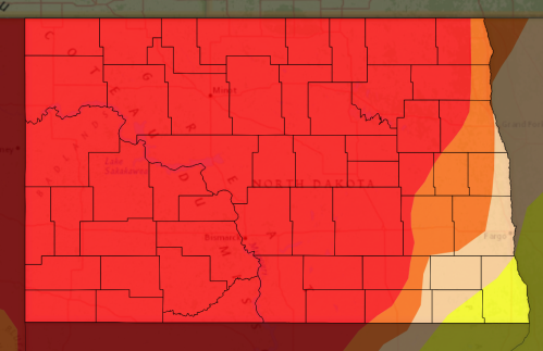 Map of North Dakota with regions shaded in red and orange, indicating varying levels of intensity or risk.