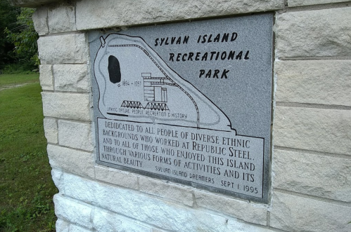 Plaque at Sylvan Island Recreational Park, honoring diverse ethnic backgrounds and their contributions to the area.