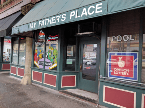 Exterior of "My Father's Place," featuring arcade games, a pool sign, and an Oregon Lottery poster.