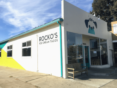 Exterior of Rocko's Ice Cream Tacos, featuring a colorful building with a dog logo and a welcoming entrance.