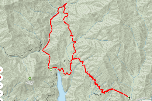 Map showing a winding red trail through mountainous terrain, with a lake at the bottom and labeled landmarks.