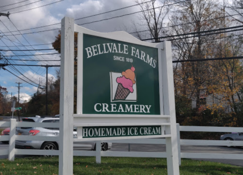 Sign for Bellvale Farms Creamery, established in 1819, featuring a colorful ice cream cone graphic.