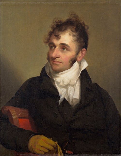 Portrait of a man with curly hair, wearing a dark coat and white cravat, seated with a thoughtful expression.