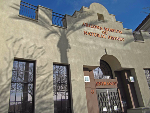 Exterior of the Arizona Museum of Natural History, featuring a prominent entrance and decorative architectural details.