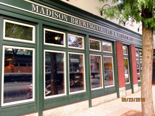 Exterior of Madison Brewing Co. pub and restaurant, featuring large windows and a brick facade. Date: 09/23/2016.