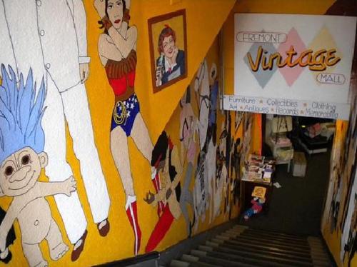 Colorful mural on a staircase leading to the Fremont Vintage Mall, featuring various vintage characters and items.